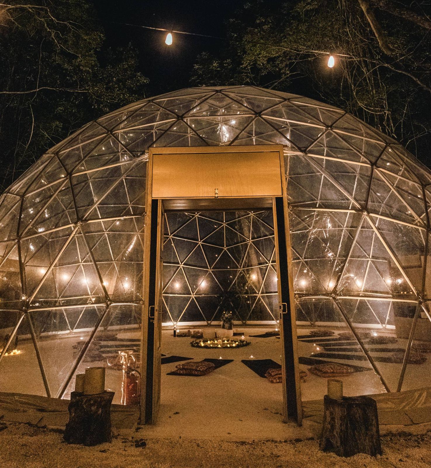 Amaite lit up at night beneath the jungle canopy